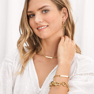 Gorjana Lou Tag Necklace. Go for gold and be anything but plain in this bold chain link necklace. 15" to 16" adjustable chain Bar is approximately 1 1/4" across Lobster claw closure. Available in 18k gold plated brass.