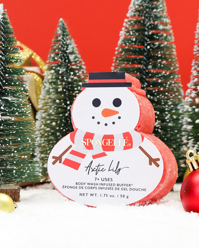 Snowman-shaped product with a label in front of Christmas trees and ornaments.