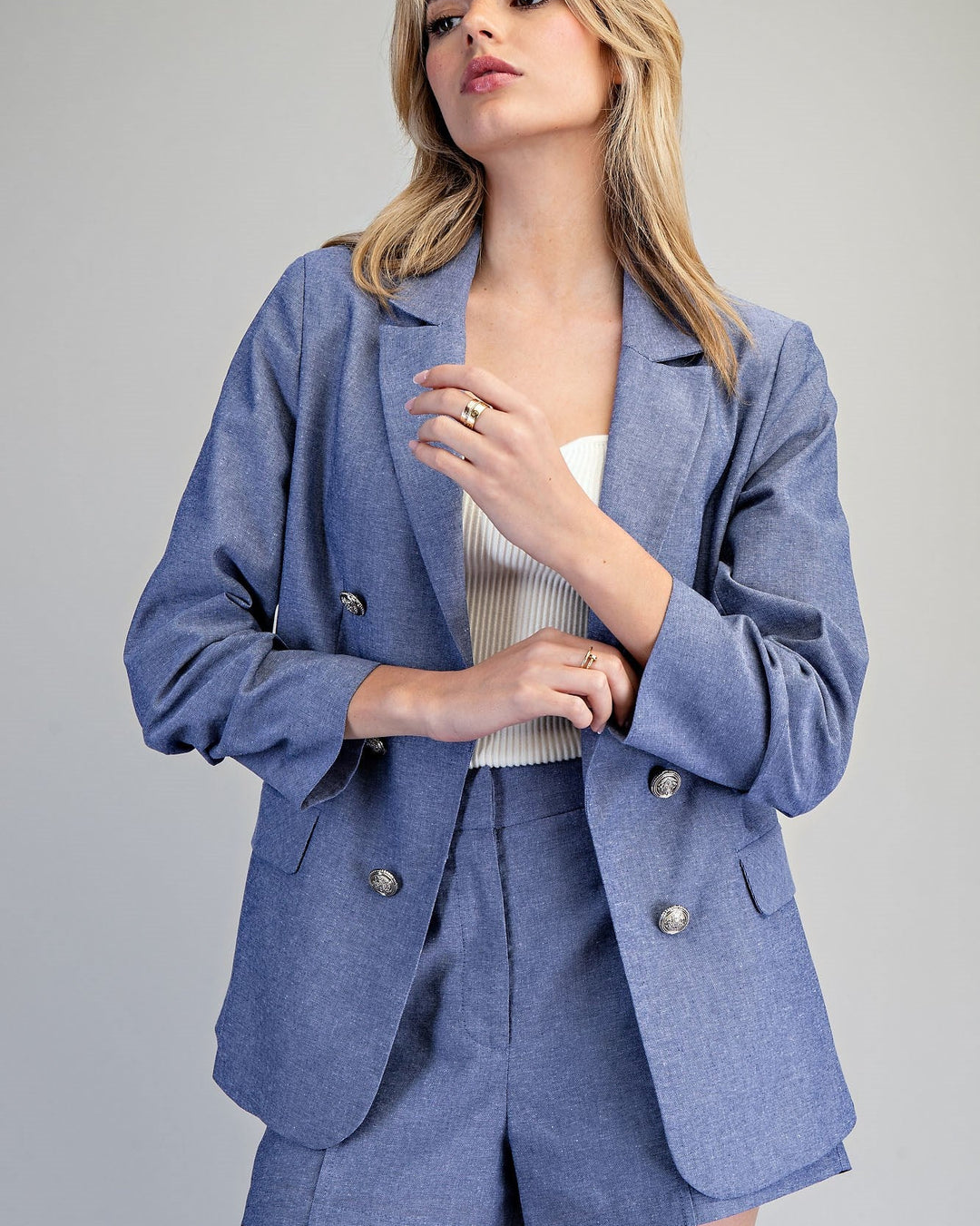 Woman wearing a blue suit with a plain background