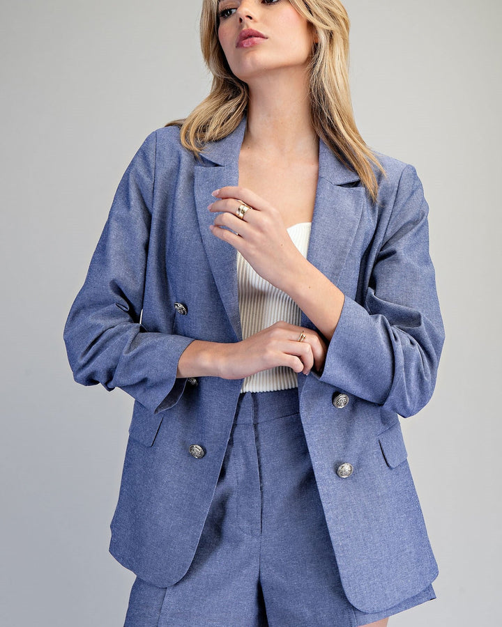 Woman wearing a blue suit with a plain background