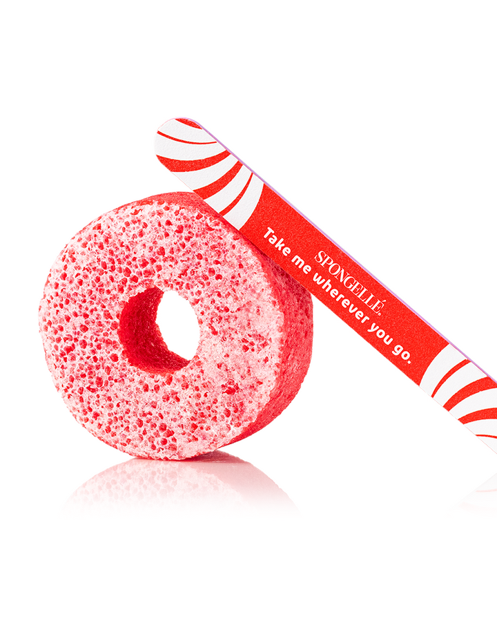 Red sponge with a red and white handle on a white background