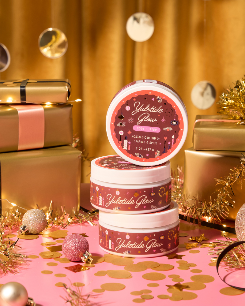 Jars of 'Yuletide Glow' on a festive background with gold presents and decorations.