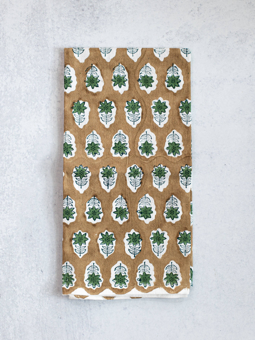 Notebook with green leaf pattern on a textured surface