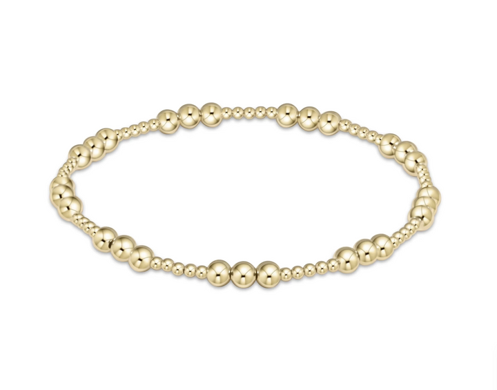 Gold beaded bracelet on a white background