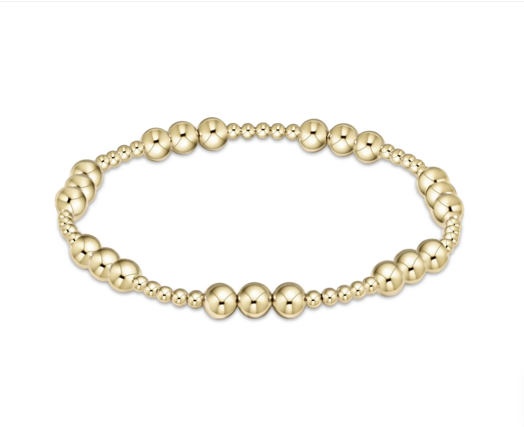 Gold beaded bracelet on a white background