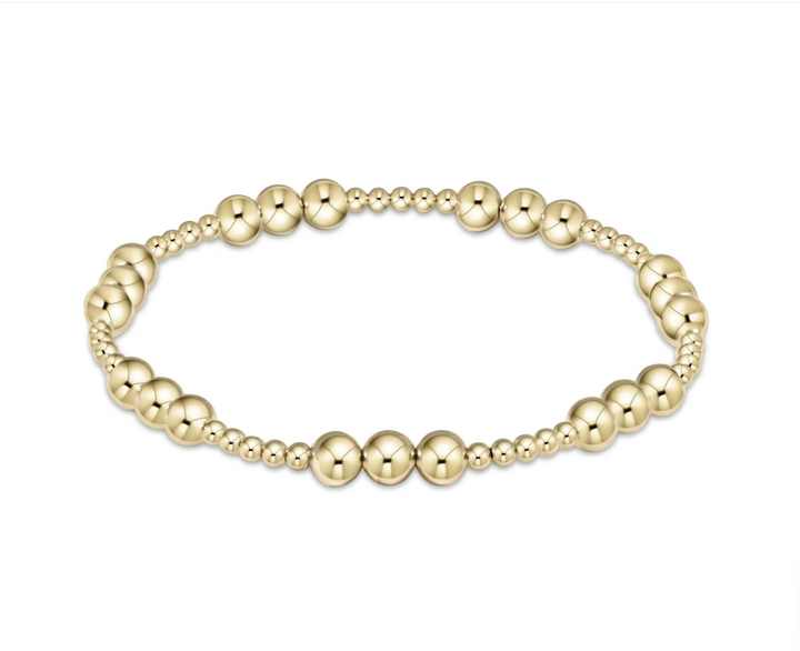 Gold beaded bracelet on a white background