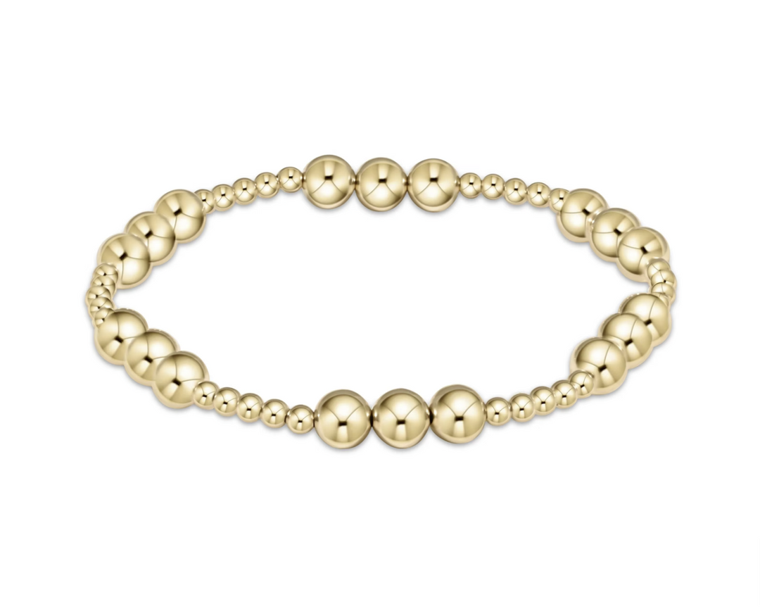 Gold beaded bracelet on a white background