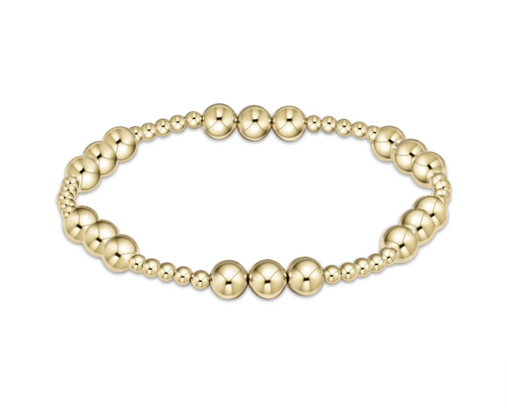 Gold beaded bracelet on a white background