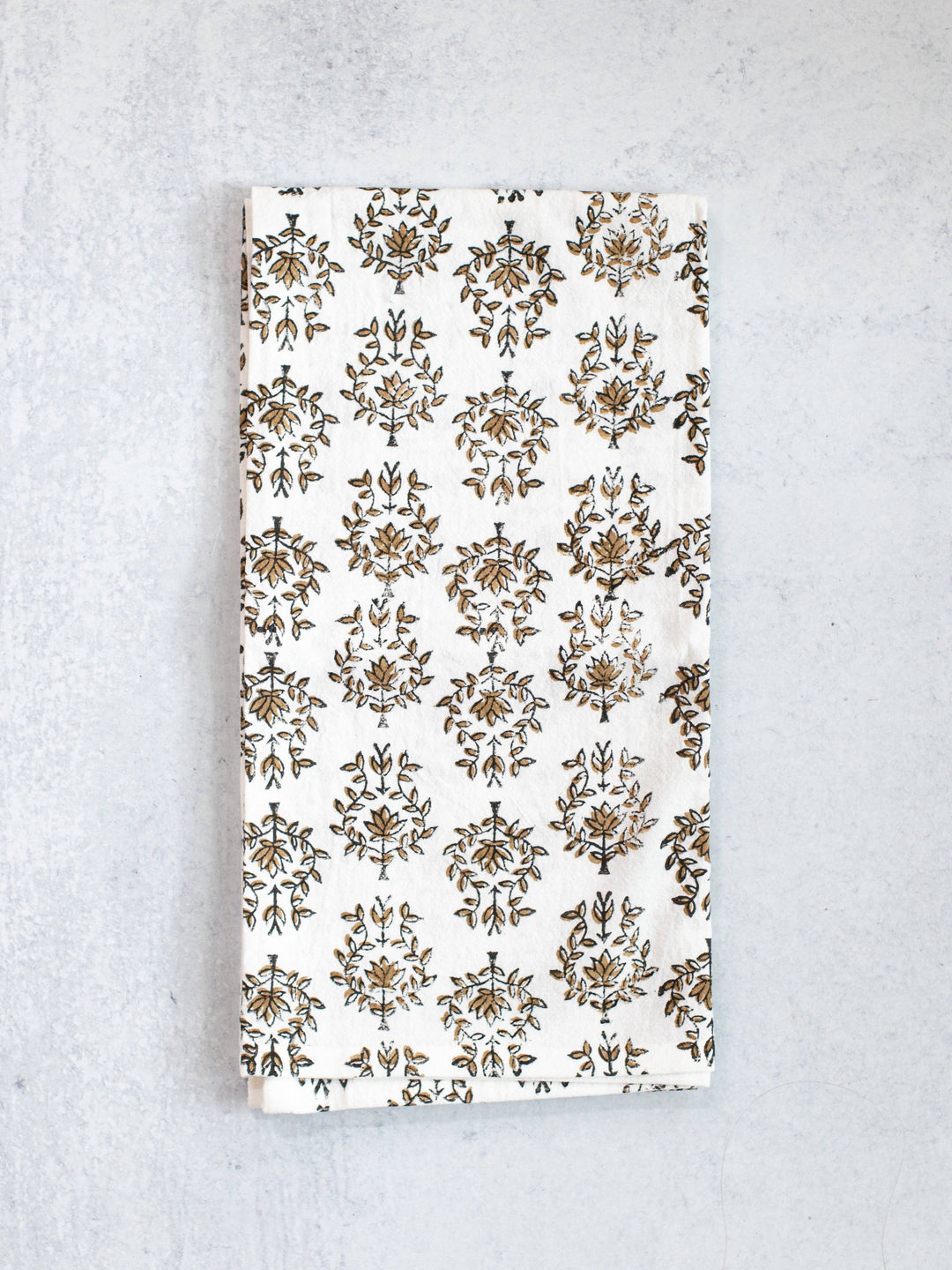 Floral patterned towel on a textured gray background