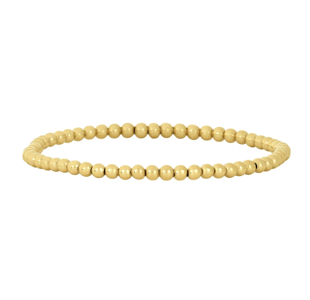 Gold beaded bracelet on a white background