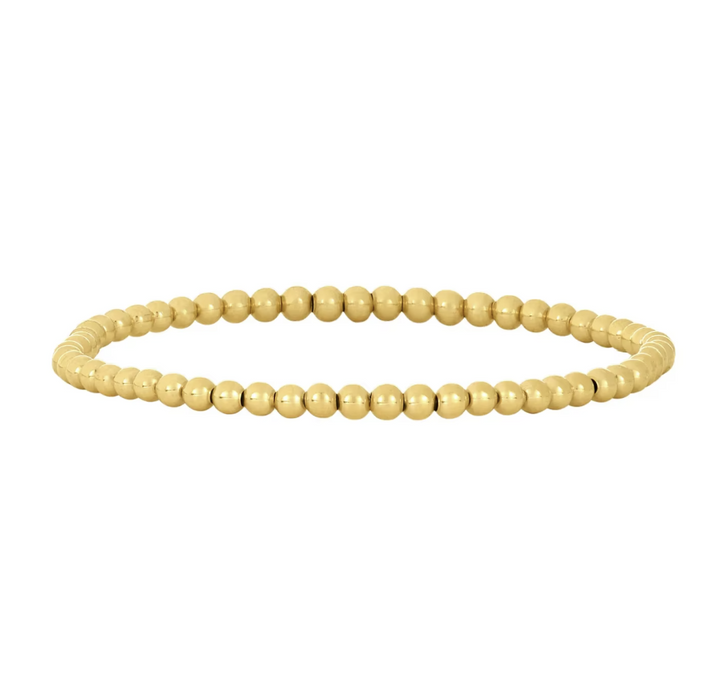 Gold beaded bracelet on a white background