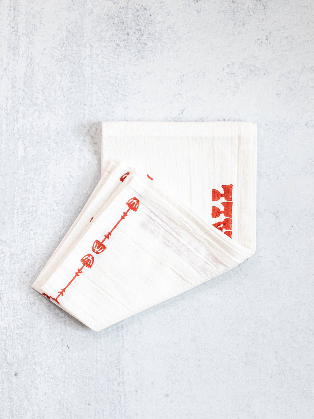 White napkins with red text on a light gray background