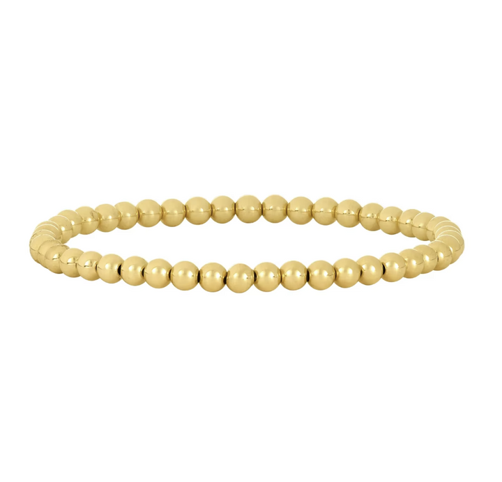 Gold beaded bracelet on a white background