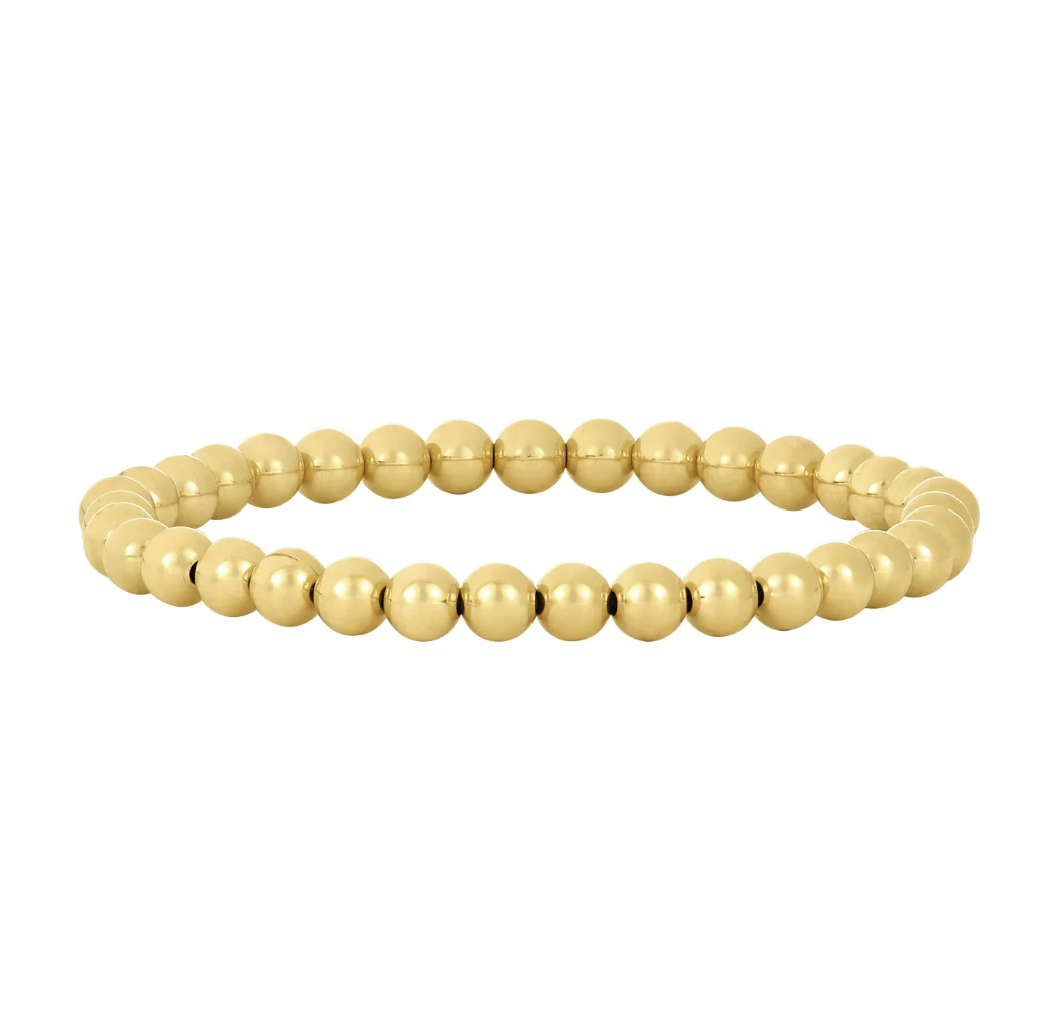Gold beaded bracelet on a white background