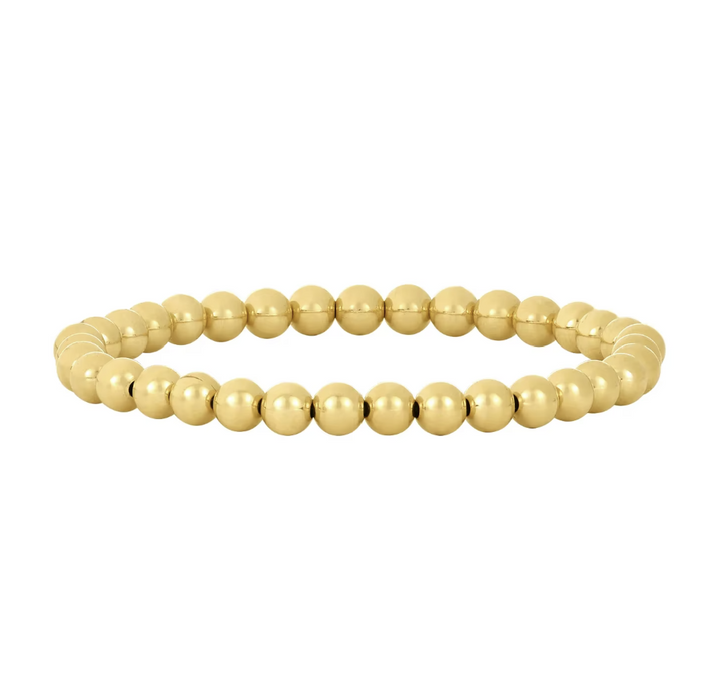 Gold beaded bracelet on a white background