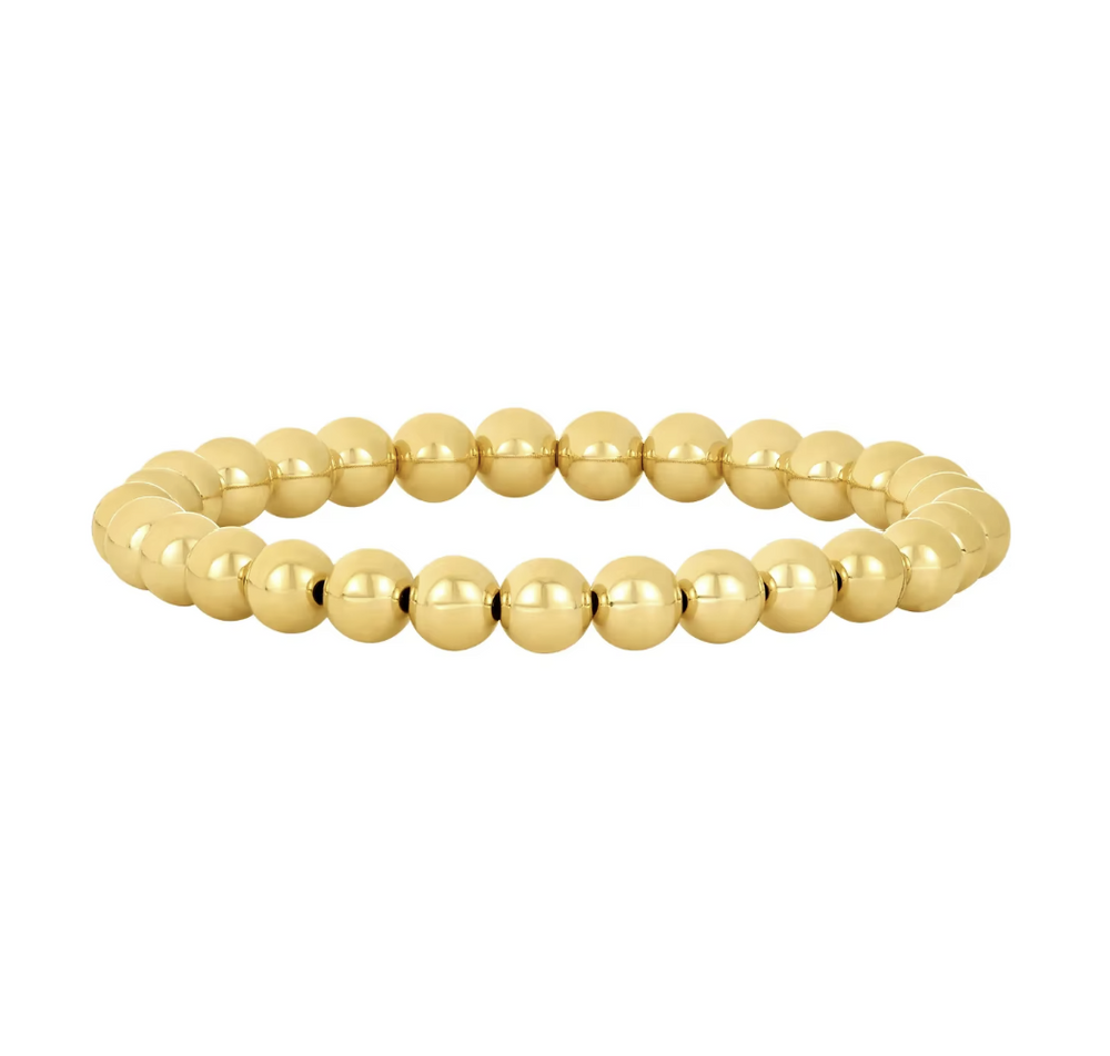 Gold beaded bracelet on a white background