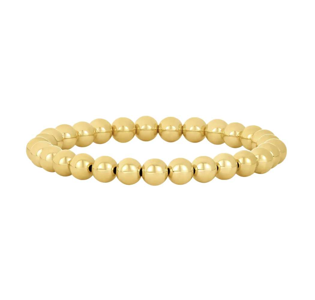 Gold beaded bracelet on a white background