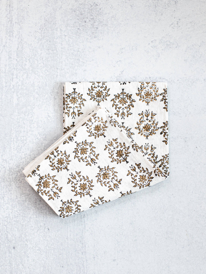Two floral-patterned boxes on a textured gray surface