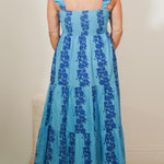 back view of woman wearing a blue print maxi dress 