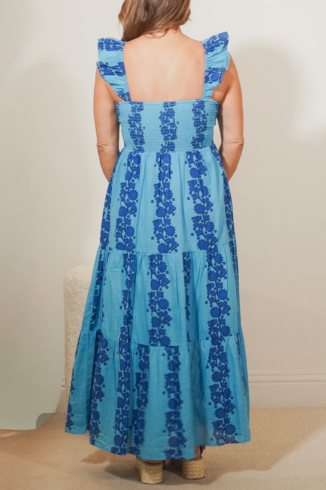 back view of woman wearing a blue print maxi dress 