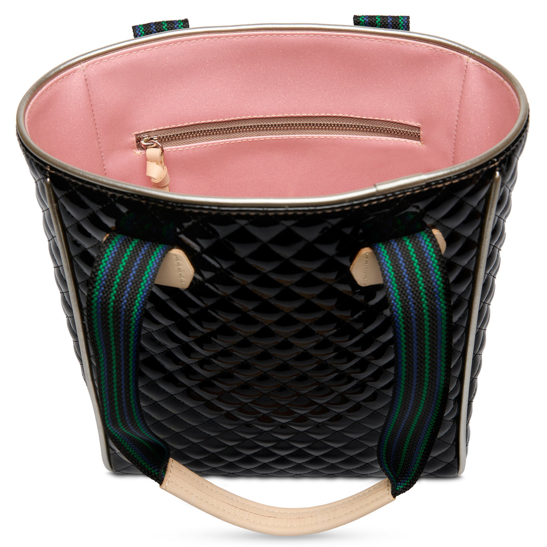 Black quilted handbag with pink interior and colorful straps on a white background