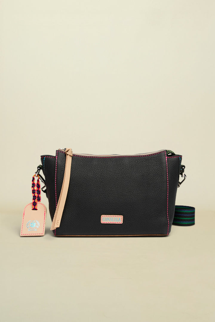 Black handbag with a strap and tag on a white background