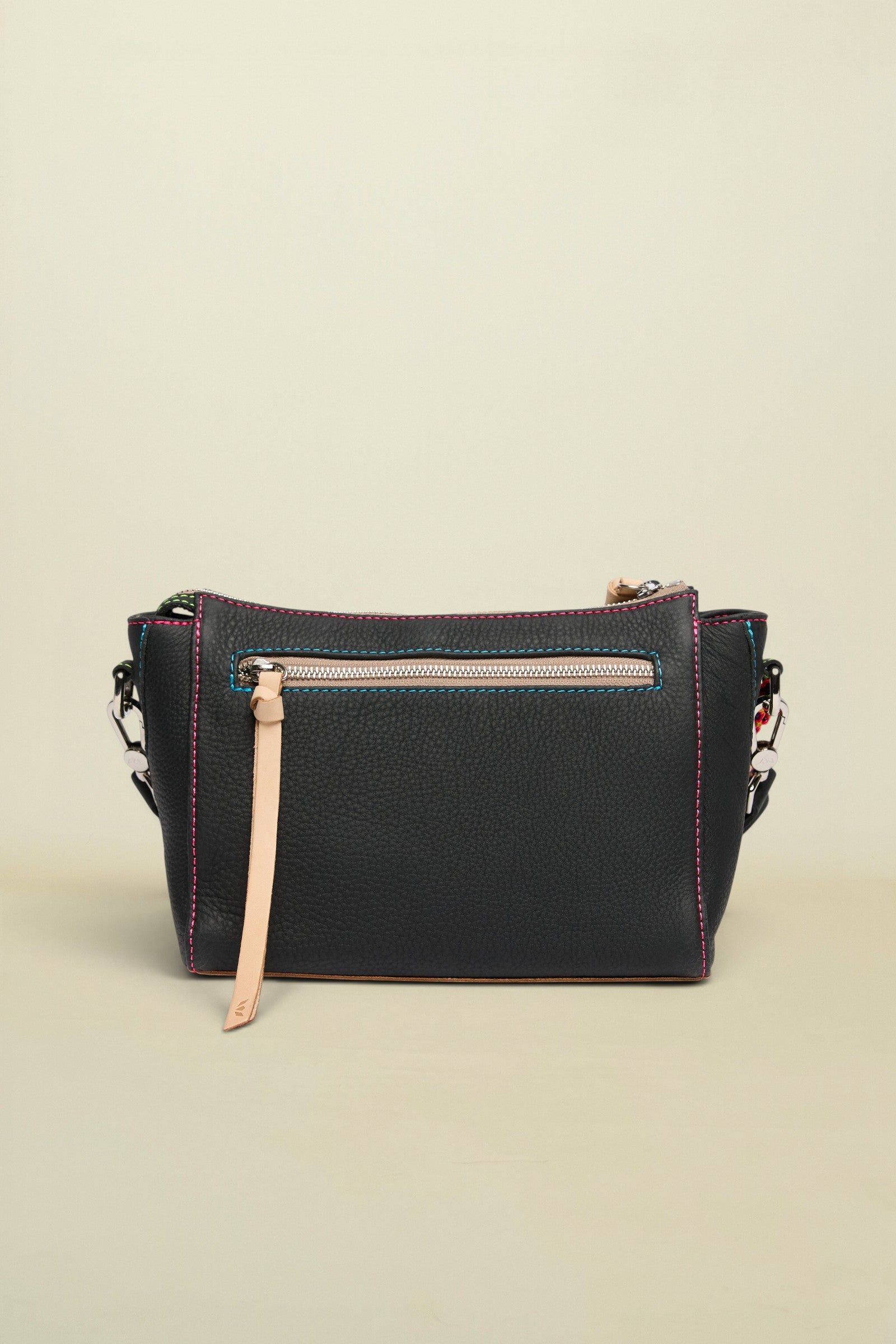 Black leather handbag with pink stitching on a white background