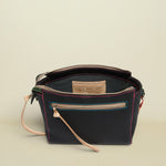 Black leather handbag with visible stitching and a strap on a white background