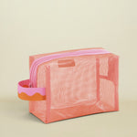 Pink mesh pouch with a handle on a white background