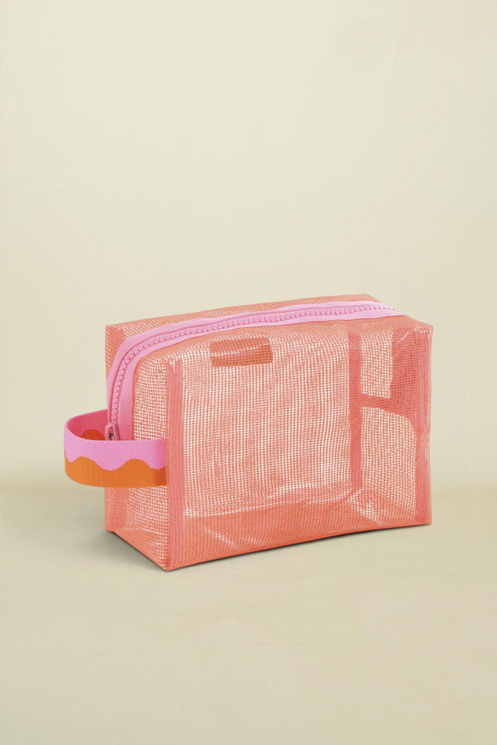 Pink mesh pouch with a handle on a white background