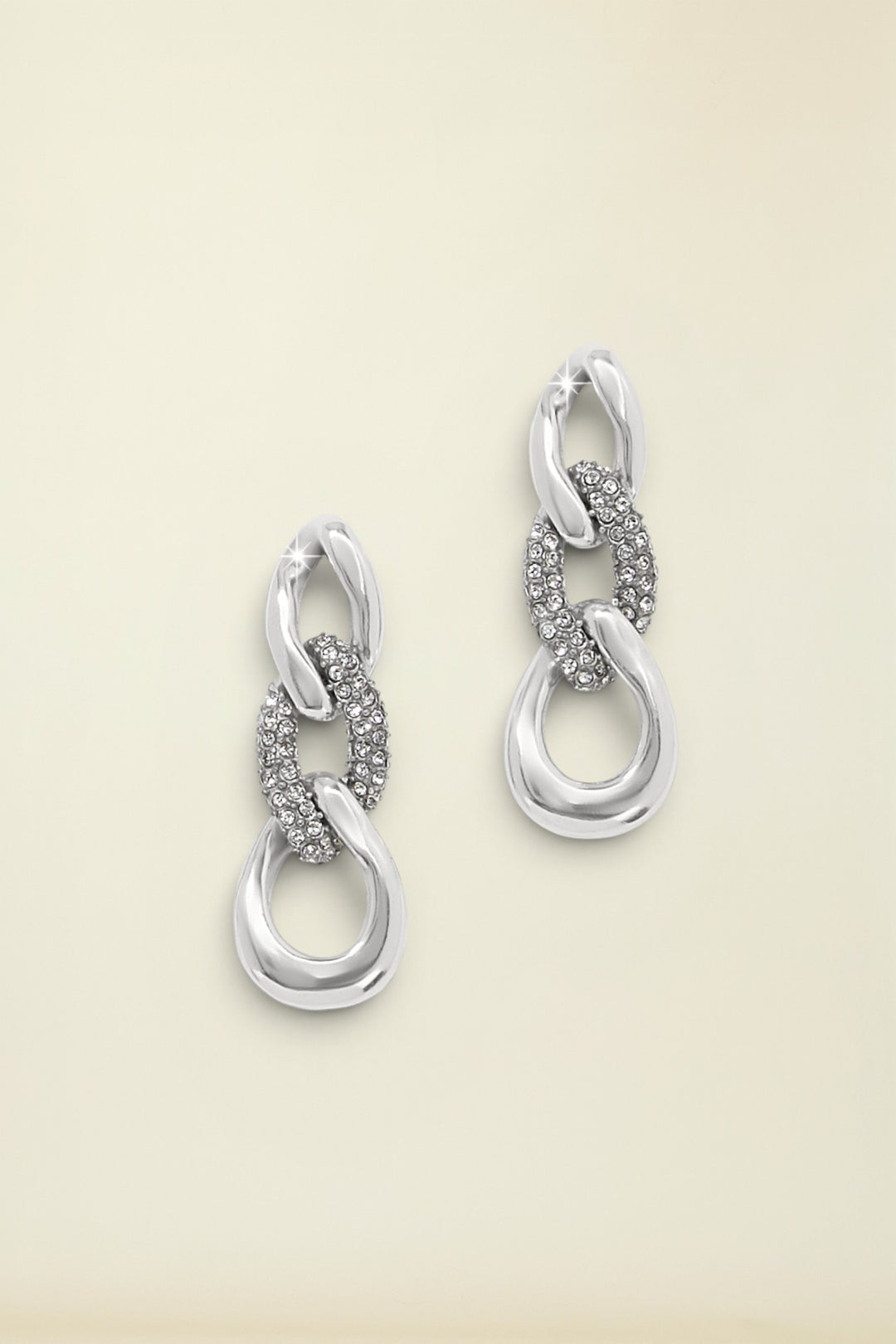 Cleo Pave Link Post Drop Earrings laying on neutral backgorund