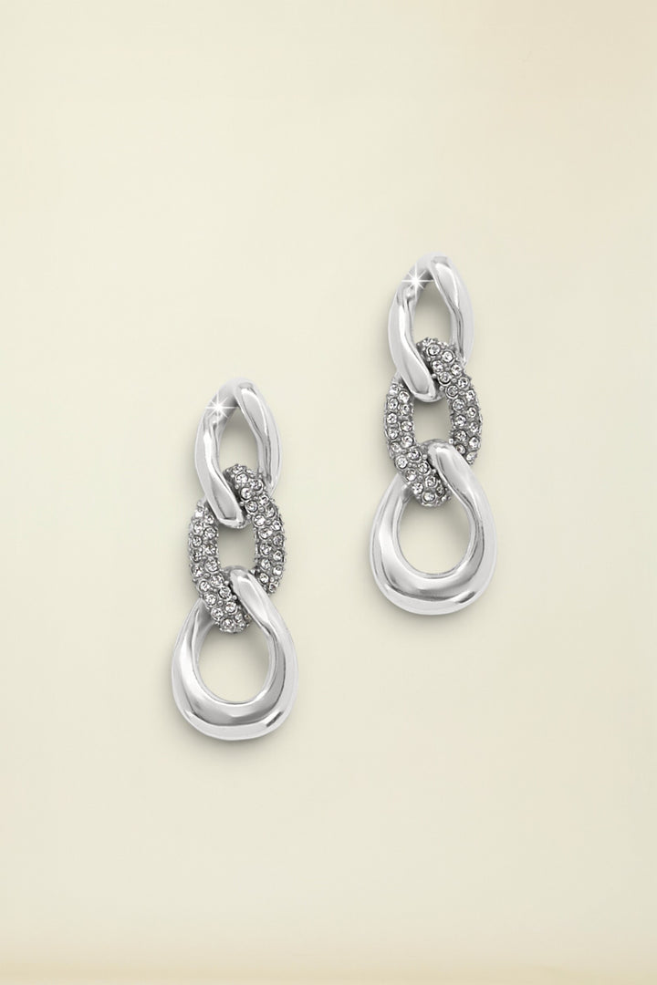 Cleo Pave Link Post Drop Earrings laying on neutral backgorund