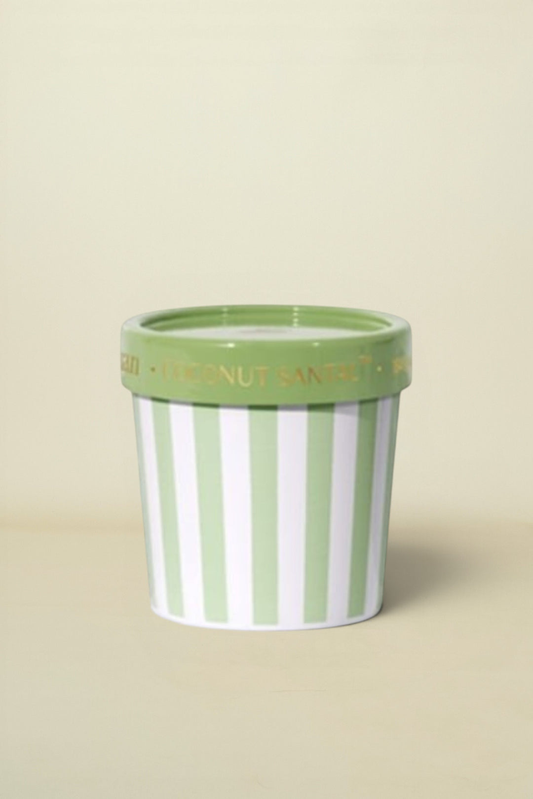 Striped candle pot with green rim on a white background