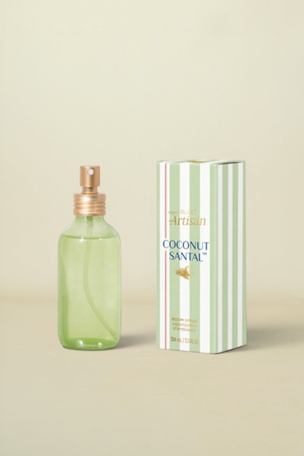Green perfume bottle with gold cap and matching box on a white background