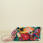 Embroidered clutch bag with floral patterns, a black heart, and decorative tassels