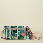 Consuela crossbody bag with a cactus print, a pink heart, and a colorful tassel