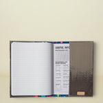 Consuela Gemma Notebook with a dark gray textured cover and lined pages with a useful info section