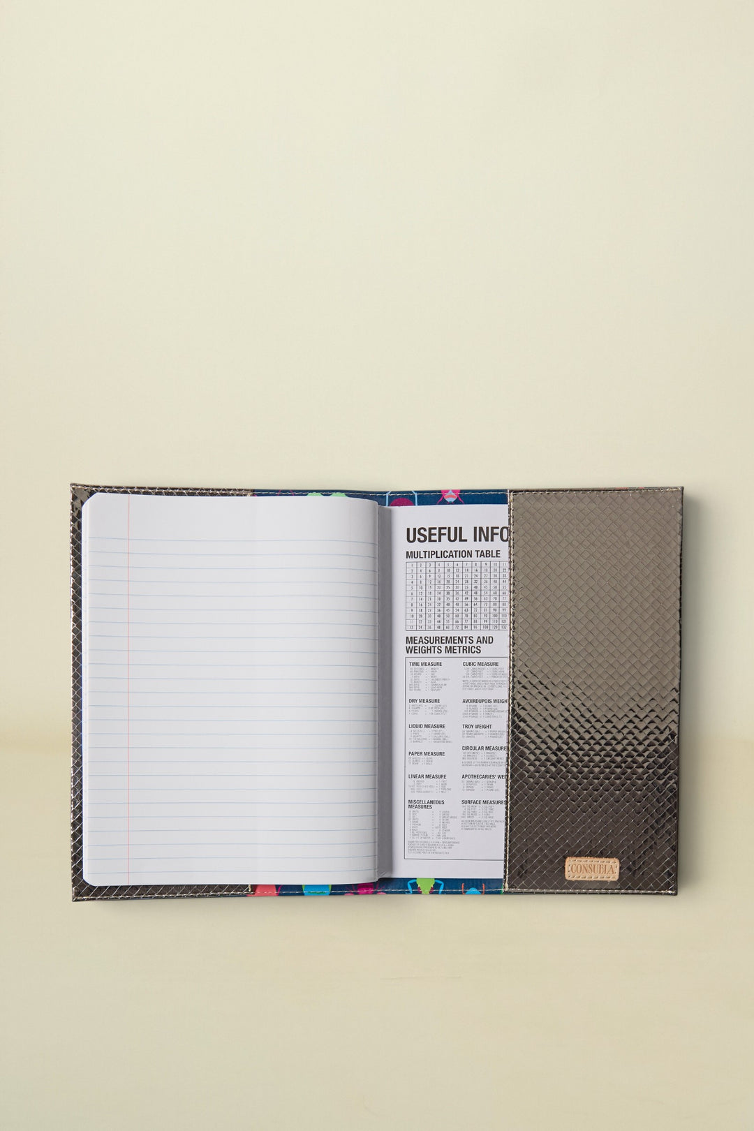Consuela Gemma Notebook with a dark gray textured cover and lined pages with a useful info section