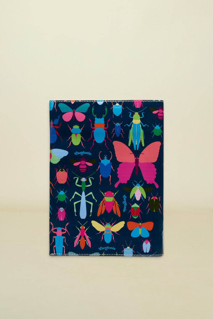 Consuela Gemma Notebook with a dark blue cover and a colorful insect pattern