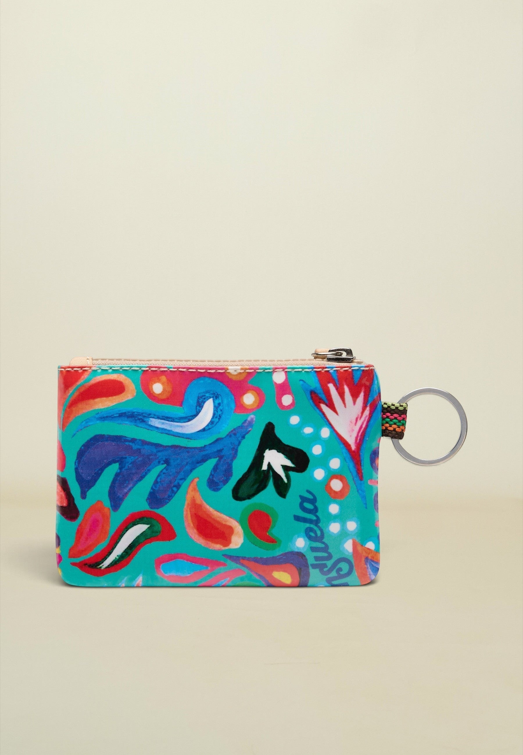 A small zippered pouch with a vibrant multicolor abstract print on a turquoise background, featuring a silver metal key ring attachment.