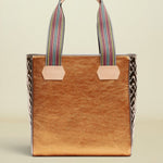 Brown tote bag with striped handles on a beige background