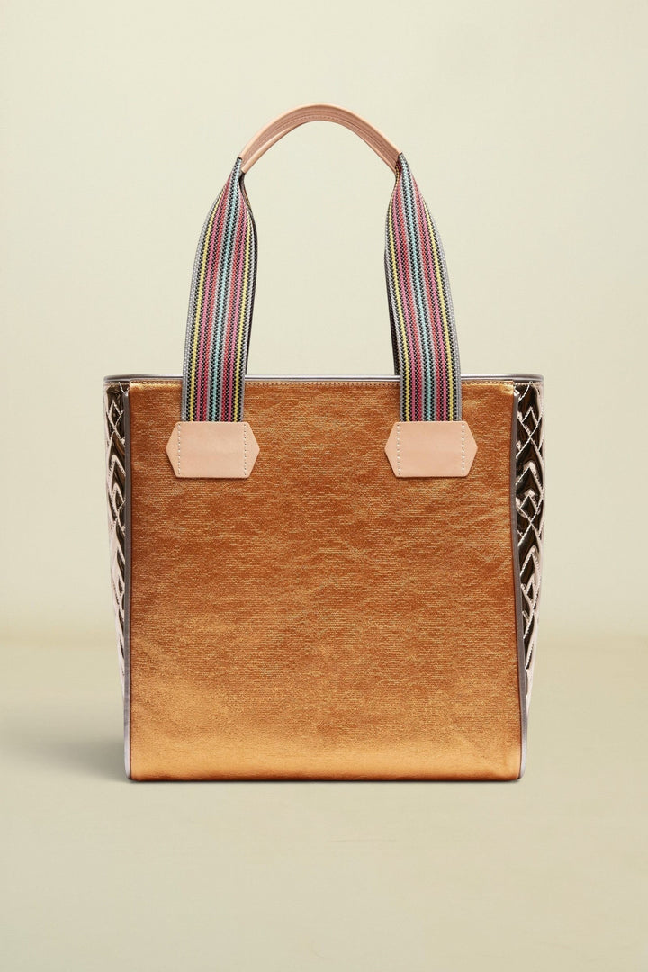 Brown tote bag with striped handles on a beige background