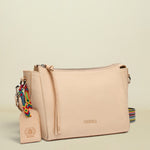 Beige handbag with a colorful strap on a white background