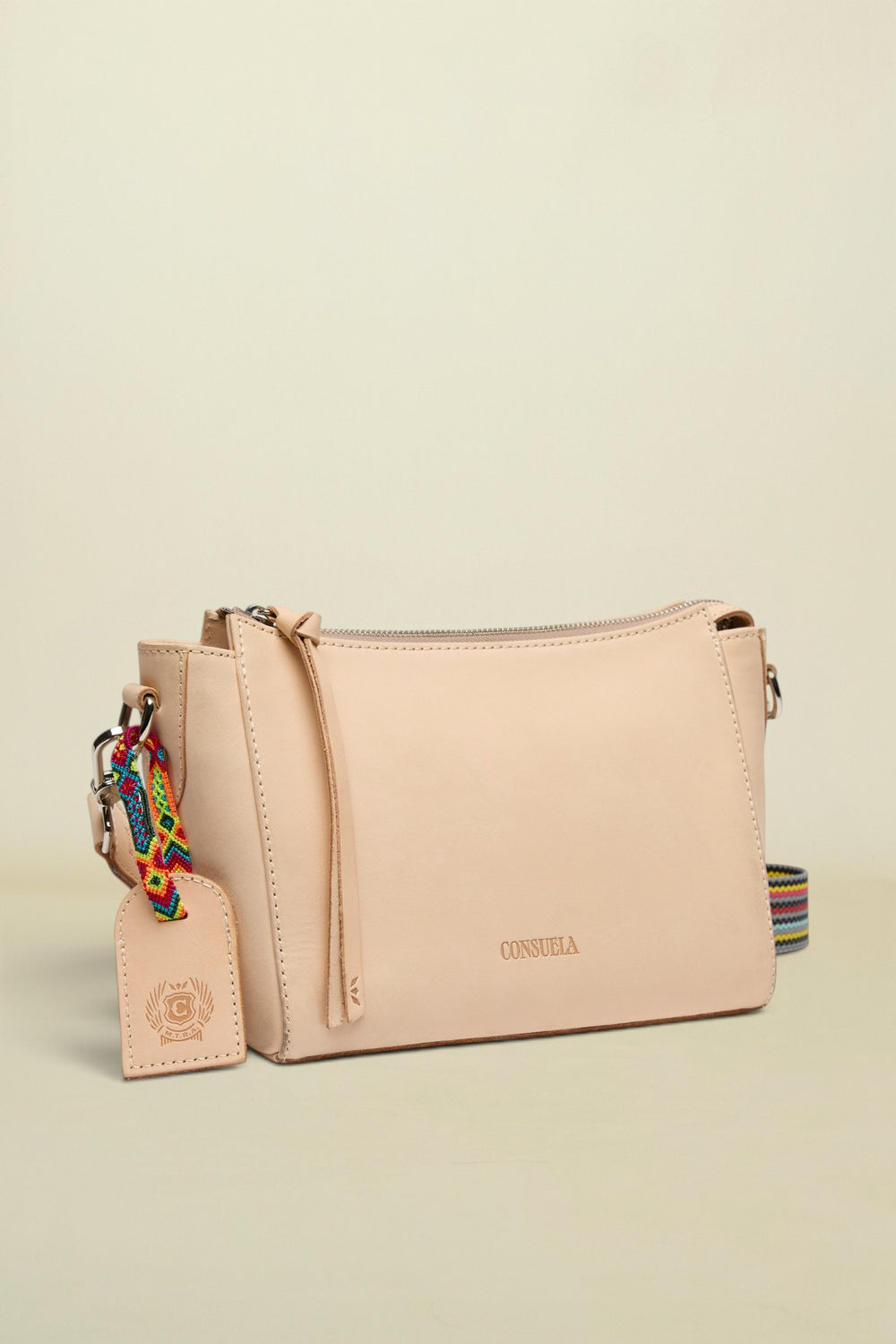 Beige handbag with a colorful strap on a white background