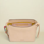 Beige handbag with colorful strap on a white background