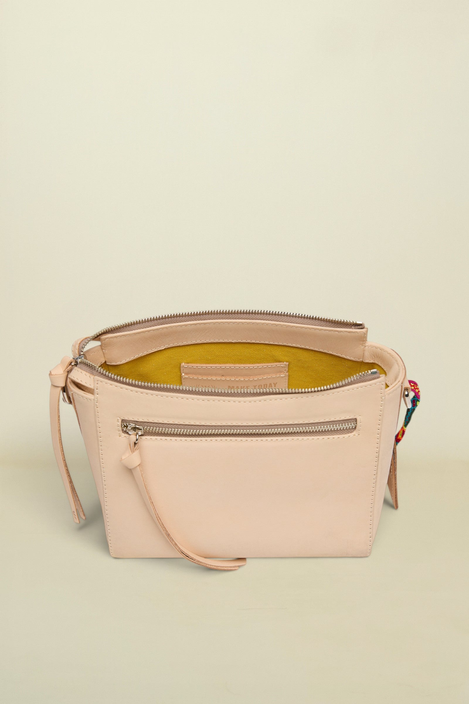 Beige handbag with a zipper on a white background