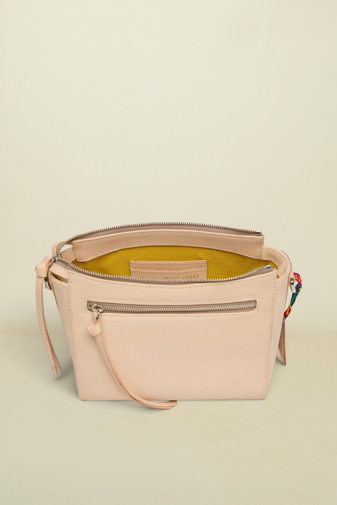 Beige handbag with a zipper on a white background