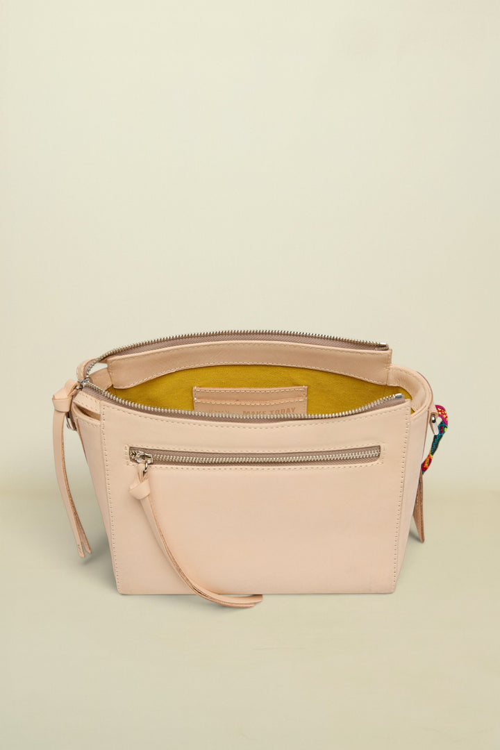 Beige handbag with a zipper on a white background