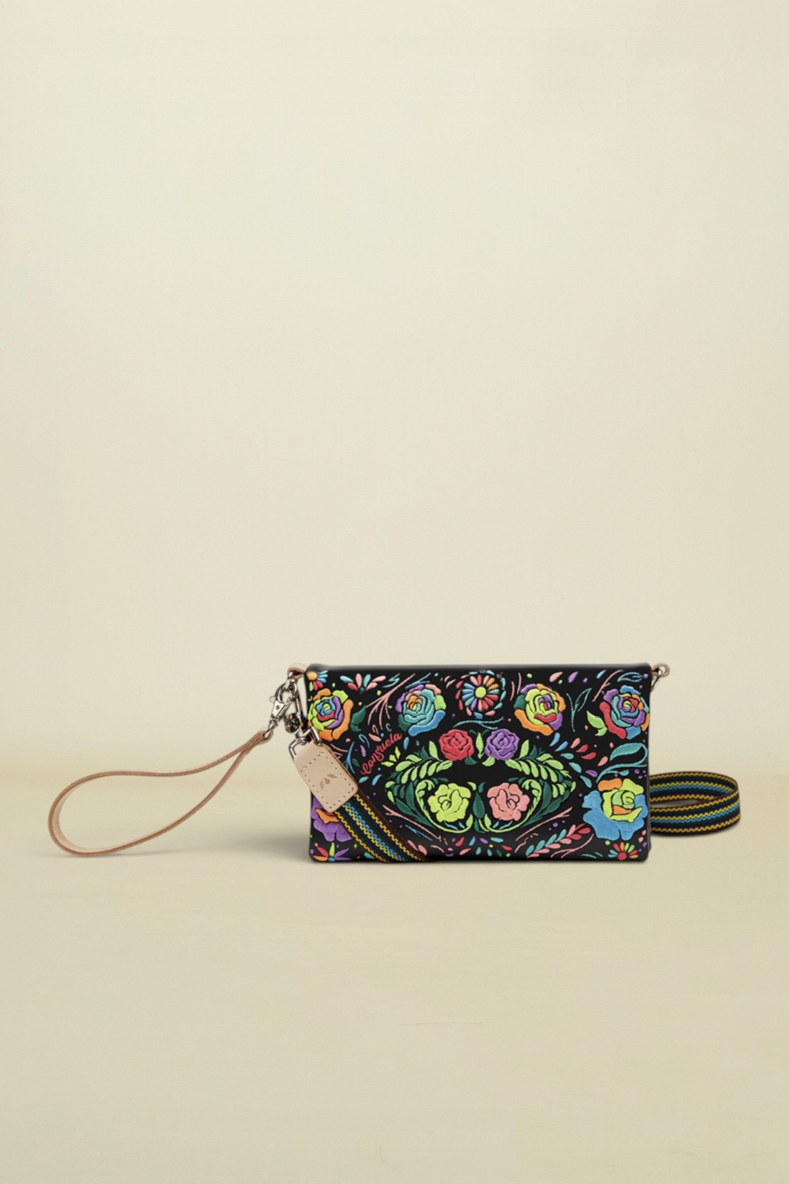 Consuela Rita Uptown Crossbody front view of black vinly with neon embroidered flowers