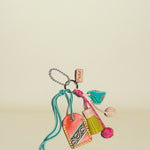 Colorful keychain with heart-shaped charm, tassel, and other decorative elements on a white background